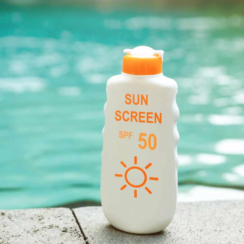 Sunscreen bottle with SPF 50 label by a pool